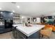Kitchen island featuring white countertop and navy cabinets, with seating and views of the adjacent living area at 3011 49Th S Ter, St Petersburg, FL 33712