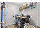 Efficient laundry room features modern washer and dryer with storage solutions and a shelf at 3011 49Th S Ter, St Petersburg, FL 33712