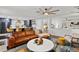 Open-concept living room featuring modern decor, a leather sofa, and a view into the kitchen area at 3011 49Th S Ter, St Petersburg, FL 33712