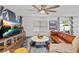 Cozy living room with leather sofa, entertainment center, and a decorative accent wall at 3011 49Th S Ter, St Petersburg, FL 33712