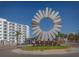 Unique public art installation on a traffic circle near a white condo building at 3011 49Th S Ter, St Petersburg, FL 33712