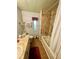 This is a shared bathroom with dual sinks, cabinets and drawers for storage, and a shower and bath combo at 34222 Canal N Dr, Pinellas Park, FL 33781