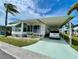 Charming single-story home with carport, awnings, well-maintained landscaping, and sunny Florida skies at 34222 Canal N Dr, Pinellas Park, FL 33781