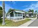 Attractive single-story home with awning, carport and well maintained landscaping, in a tropical setting at 34222 Canal N Dr, Pinellas Park, FL 33781