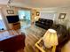 Bright living room with sliders to the lanai, wood-look floors, neutral paint, and comfortable seating at 34222 Canal N Dr, Pinellas Park, FL 33781