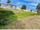 Landscaped lawn area with mature trees and lush vegetation at 34222 Canal N Dr, Pinellas Park, FL 33781