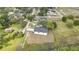 Aerial view of a home and a long driveway surrounded by expansive greenery and mature trees at 38151 Sunset Ave, Dade City, FL 33525