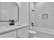 Elegant bathroom featuring quartz counters, dark hardware and a tiled tub at 38151 Sunset Ave, Dade City, FL 33525