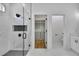 Primary bathroom featuring a glass shower, walk-in closet, and adjoining water closet at 38151 Sunset Ave, Dade City, FL 33525