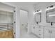Well lit bathroom with double vanity, shower with glass door, and walk in closet at 38151 Sunset Ave, Dade City, FL 33525
