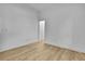 Minimalist bedroom with wood floors and a doorway to another room at 38151 Sunset Ave, Dade City, FL 33525