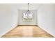 Bright dining room features wood-look floors, modern chandelier, and large window at 38151 Sunset Ave, Dade City, FL 33525