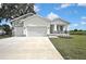 Lovely single-Gathering home featuring a two-car garage and a manicured lawn at 38151 Sunset Ave, Dade City, FL 33525
