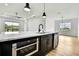 Modern kitchen with stainless steel appliances, quartz countertops, and a center island at 38151 Sunset Ave, Dade City, FL 33525
