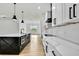 Modern kitchen boasting white cabinets, a black island, and stainless steel appliances at 38151 Sunset Ave, Dade City, FL 33525