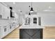 Modern kitchen with a large island, breakfast bar, and stainless steel appliances at 38151 Sunset Ave, Dade City, FL 33525