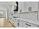 Modern kitchen with white cabinets, quartz countertops, subway tile backsplash, and stainless appliances at 38151 Sunset Ave, Dade City, FL 33525