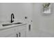 Laundry room with new sink, quartz countertop, and white cabinets at 38151 Sunset Ave, Dade City, FL 33525