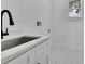 Bright laundry room with modern fixtures, cabinets, and sink at 38151 Sunset Ave, Dade City, FL 33525