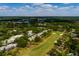 Aerial view of townhome community adjacent to the golf course amid lush, mature trees at 4207 Fairway Run, Tampa, FL 33618