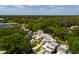 An aerial view of a community of townhomes and mature landscaping with a golf course and lake nearby at 4207 Fairway Run, Tampa, FL 33618