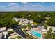 Aerial view of townhome community featuring a pool, lush landscaping, and convenient parking at 4207 Fairway Run, Tampa, FL 33618