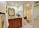 Bathroom with a wood vanity, sink, mirror, and tile flooring at 4207 Fairway Run, Tampa, FL 33618