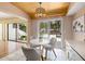 Bright breakfast nook with a wood ceiling, white table, chairs, and a view of the screened patio at 4207 Fairway Run, Tampa, FL 33618