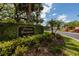 Community sign for Fairway Townhouses at Carrollwood Village amid lush greenery and mature trees at 4207 Fairway Run, Tampa, FL 33618