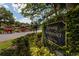 A view of the 'Fairway Townhouses at Carrollwood Village' community sign, surrounded by lush landscaping at 4207 Fairway Run, Tampa, FL 33618
