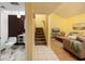 Inviting entryway showcases a glimpse of the living room, stairs, and bathroom at 4207 Fairway Run, Tampa, FL 33618
