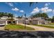 Charming townhouses boast manicured lawns, mature trees, and private garages on a sunny day at 4207 Fairway Run, Tampa, FL 33618