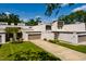 Townhome exterior featuring an attached garage, well-maintained landscaping, and neutral color palette at 4207 Fairway Run, Tampa, FL 33618