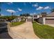 Inviting townhome exterior with a well-manicured lawn, long driveway, and attached garage at 4207 Fairway Run, Tampa, FL 33618