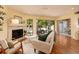 Inviting living room with a fireplace, hardwood floors, and view to the screened-in patio at 4207 Fairway Run, Tampa, FL 33618