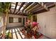 Cozy patio area with a pergola overhead, beautiful plants, and a serene outdoor ambiance at 4207 Fairway Run, Tampa, FL 33618