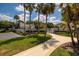 Gated community pool entrance with lush landscaping and mature palm trees creates a resort-like feel at 4207 Fairway Run, Tampa, FL 33618