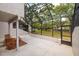 Enclosed patio featuring neutral wicker furniture, concrete floor, and a view of the spacious backyard at 4207 Fairway Run, Tampa, FL 33618