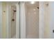 Modern shower with dual showerheads, white tile, and a glass door, creating a spa-like experience at 4207 Fairway Run, Tampa, FL 33618