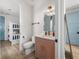 Adorable bathroom featuring trendy salmon-colored vanity, a mirror and a cute bunk room adjacent to it at 4215 Saltwater Pearl Way, Cortez, FL 34215