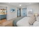 Bright bedroom with ensuite bathroom and TV at 4215 Saltwater Pearl Way, Cortez, FL 34215