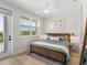 This bright bedroom features a comfortable bed, stylish decor, and ample natural light from the large window at 4215 Saltwater Pearl Way, Cortez, FL 34215