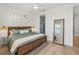 A tranquil bedroom with a cozy bed, decorative accents, a large mirror, and plenty of space to relax and unwind at 4215 Saltwater Pearl Way, Cortez, FL 34215