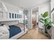 Light and airy bedroom with bunk beds and view of a bathroom and a potted plant at 4215 Saltwater Pearl Way, Cortez, FL 34215