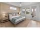 Stylish bedroom with neutral tones, textured accent wall, and balcony access at 4215 Saltwater Pearl Way, Cortez, FL 34215