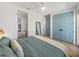 View of a cozy bedroom featuring stylish decor, ample closet space, and access to an adjoining bathroom at 4215 Saltwater Pearl Way, Cortez, FL 34215