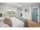 Well-lit bedroom with ensuite bathroom, TV, and large windows for natural light at 4215 Saltwater Pearl Way, Cortez, FL 34215