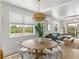 Bright dining area with a round table and views leading into the living room at 4215 Saltwater Pearl Way, Cortez, FL 34215