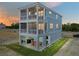 Beautiful three-story beach house with screened porches, a patio, and outdoor seating at 4215 Saltwater Pearl Way, Cortez, FL 34215