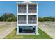 Attractive three-story home with screened porches and an outdoor patio area at 4215 Saltwater Pearl Way, Cortez, FL 34215
